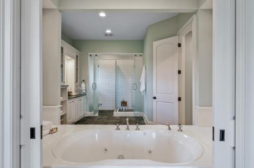 Beautifully appointed, the primary ensuite features a relaxing soaking tub, separate tiled shower, and stylish finishes.