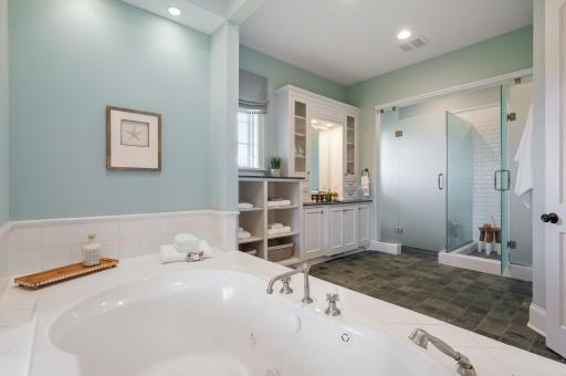 Thoughtfully designed, the primary ensuite features a well-defined layout with a separate shower and soaking tub, creating a functional and elegant space.