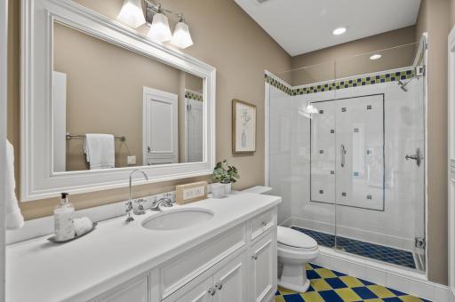 Convenient ensuite bathroom on the upper level, featuring a stylish shower and vanity.