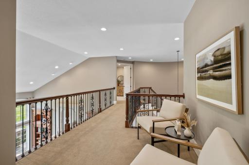 Enjoy the open and airy ambiance of the upper level landing, a versatile space for a cozy reading nook or sitting area.