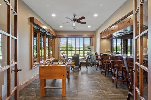 The lower level bar offers a convenient gathering spot with views and access to the game area and theater.