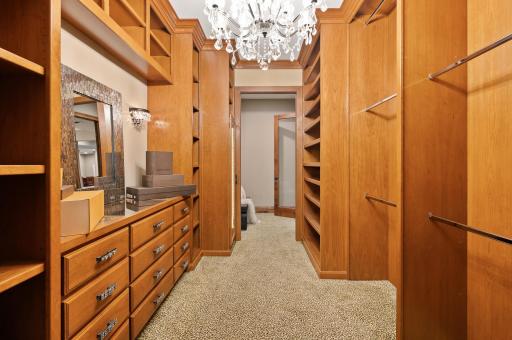 Abundant shelving, drawers, and hanging space provide unparalleled storage in this large custom closet on the lower level.