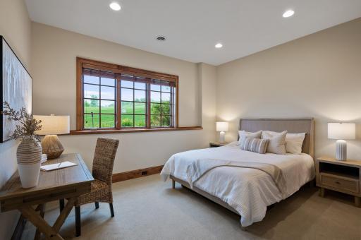 Bright and welcoming, this lower level bedroom provides a comfortable space for guests or family.