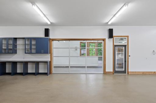 Heated flex room with a glass garage door entrance â a unique and versatile space within the 6-car garage.