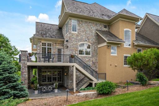 Multi-level outdoor living with a spacious deck and inviting patio.