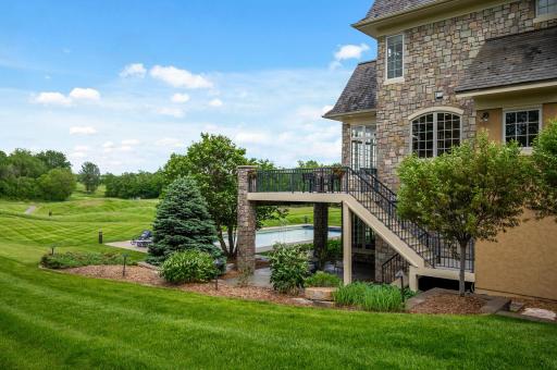 Enjoy your private pool and upper deck, all while overlooking the expansive backyard and views of the golf course.