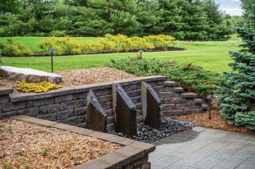 This striking water feature adds a unique design element and a peaceful ambiance to the outdoor space.