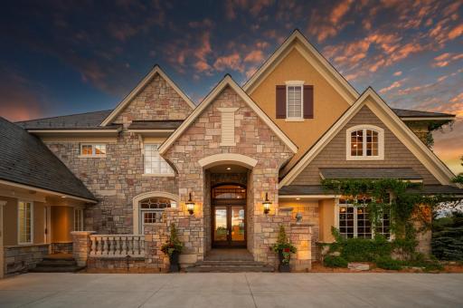 A stunning close-up of the grand front entrance of this exceptional home.