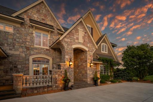 As the sun sets, the elegance of the front entrance is beautifully illuminated.