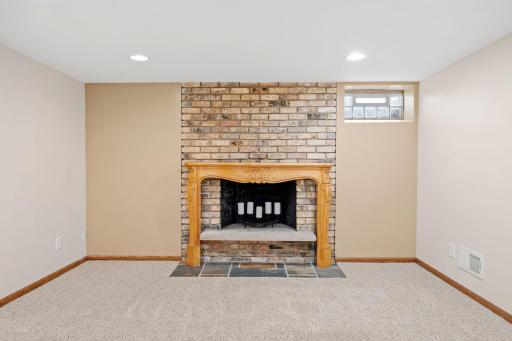 Decorative fireplace in lower level family room