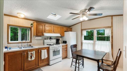 The kitchen and dining area overlook the wooded backyard.