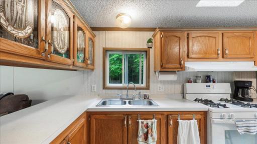 The kitchen and dining area overlook the wooded backyard.