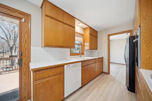Kitchen provides ample cabinets and counter space with a window and aChina sink