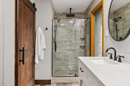Separate shower with rainhead and larger soaking tub invite you to unwind at the end of the day.