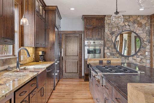 The pocket door leads to the pantry and mudroom with custom storage and main floor laundry.