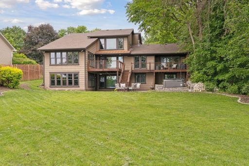 Walls of glass all along the lake side of the home are impressive.