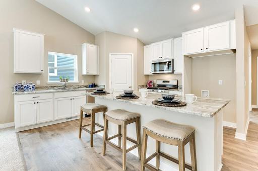 Large open kitchen with huge island and walk in pantry. Pictures are of model home. Actual finishes will vary.