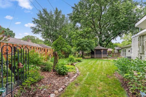 In addition to lovely gardens, this yard offers ample space for running and playing.