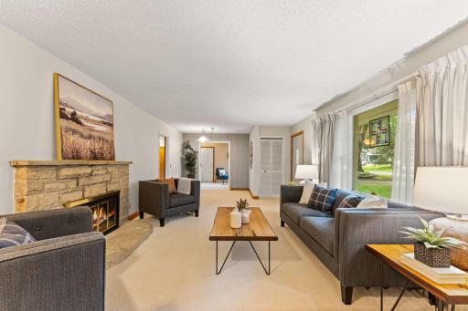 The living area features large windows, allowing sunlight to fill the room.