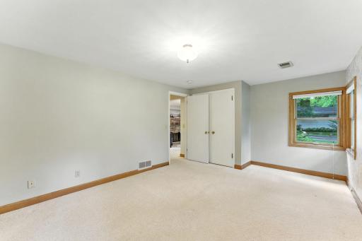 In addition to the closet this lengthy bedroom offers ample space for an armoire or two.
