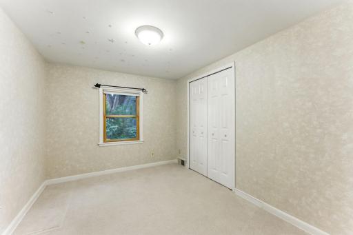The third bedroom has a pretty, wooded view and nice closet space.