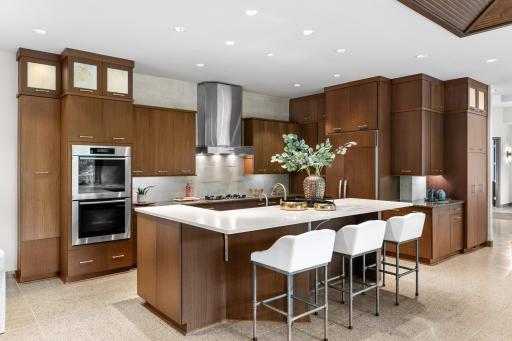 High-end Miele appliances with double ovens, Sub-Zero refrigerator/freezer, and Fisher & Paykel double-drawer dishwasher.