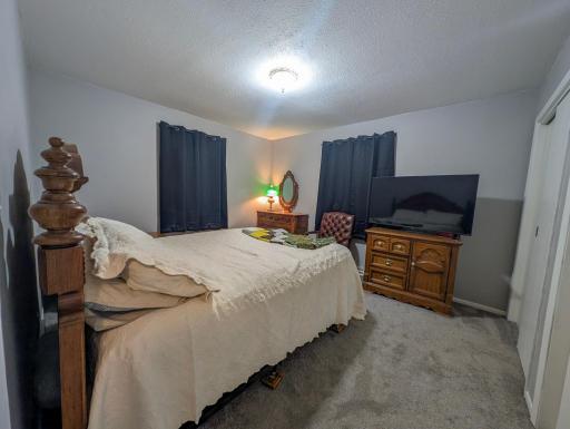 Comfortable main-floor bedroom with peaceful views. Wake up to natural light and the gentle sounds of nature just outside your window.