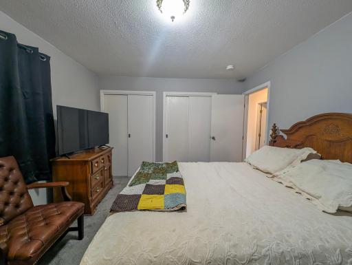 Comfortable main-floor bedroom with peaceful views. Wake up to natural light and the gentle sounds of nature just outside your window.