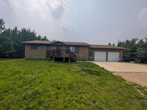 Welcome home to this peaceful retreat! Mature pines frame the front deck, perfect for sipping coffee while soaking in the sights and sounds of wildlife.