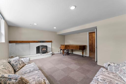 The lower level enters into a welcoming family room that features carpeting and a gas burning stove—a perfect setting for movie nights or relaxing with a book.
