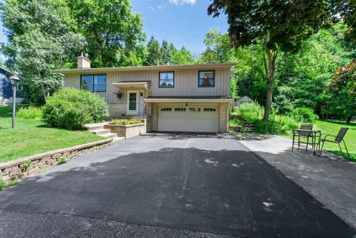 Step out to the attached 2-car garage, complete with a built-in workbench and remote opener—great for hobbies, tools, and year-round vehicle protection. The large driveway and roof were both redone in 2021.