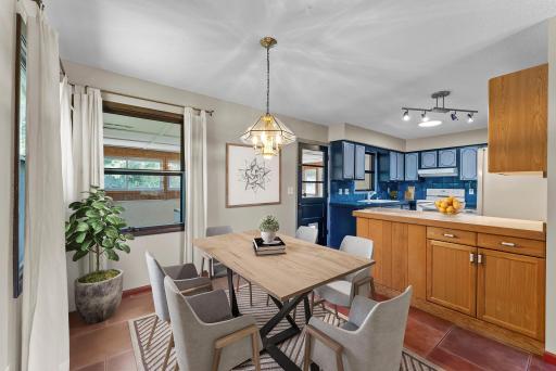 The home flows effortlessly into a designated dining area with tile flooring and an elegant light fixture—an ideal spot for everything from casual meals to dinner parties.