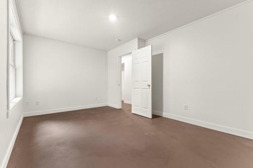 Lower-level fourth bedroom located at the back of the home for added privacy.