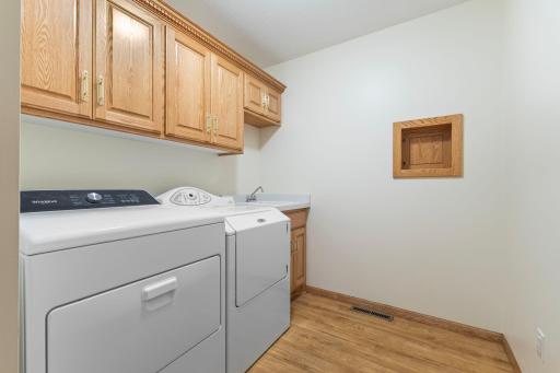 All living facilities are on the main level, including a laundry room with cabinets and a convenient sink.