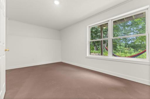 Lower-level fourth bedroom located at the back of the home for added privacy.