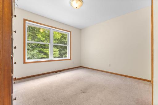 Back-facing third bedroom with fresh paint and newly cleaned carpet.