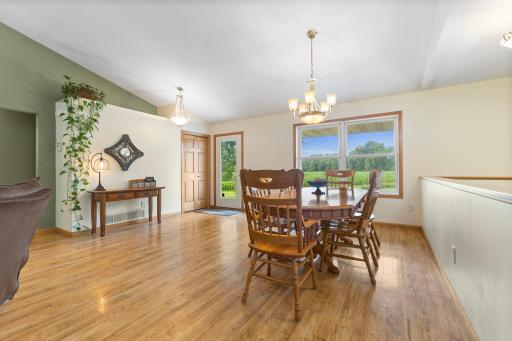 Dining and entryway filled with natural light from front-facing windows.