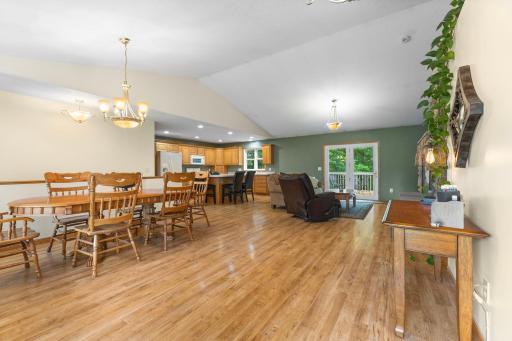 Bright and open view from the front entrance featuring vaulted ceilings, natural light, and an airy floor plan.