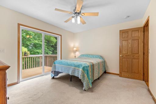 Private primary bedroom with ensuite, walkout to a deck, and freshly cleaned carpet.