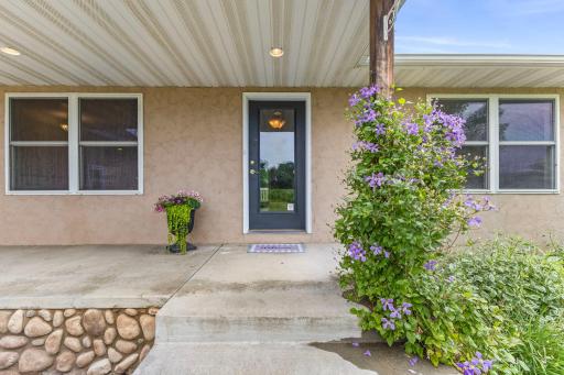 Welcoming front porch with blooming flowers and inviting entry.