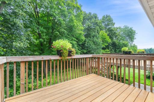 Private deck off the primary bedroom offers peaceful river views.