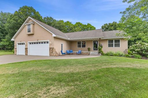 Charming front view with inviting patio and cozy covered porch.