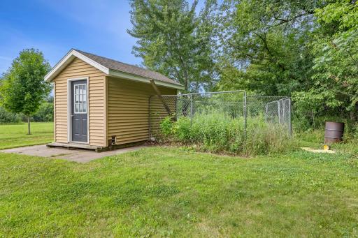 Includes a storage shed and space ideal for a dog kennel or chicken coop.