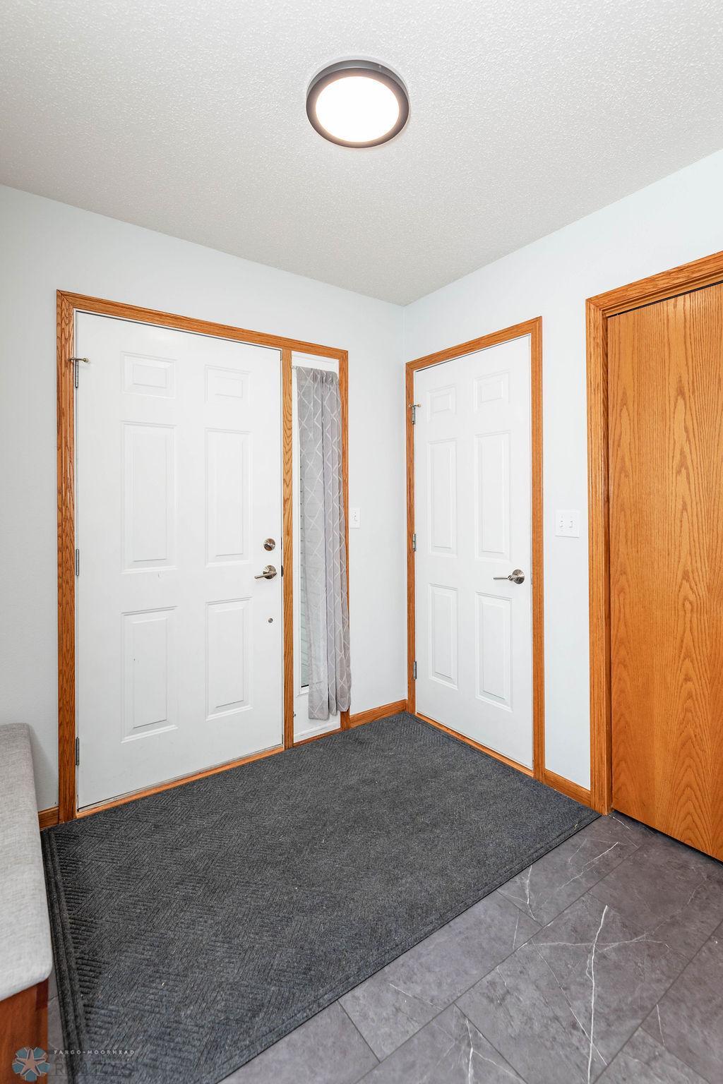 Spacious foyer w/ garage entrance & storage/coat closet