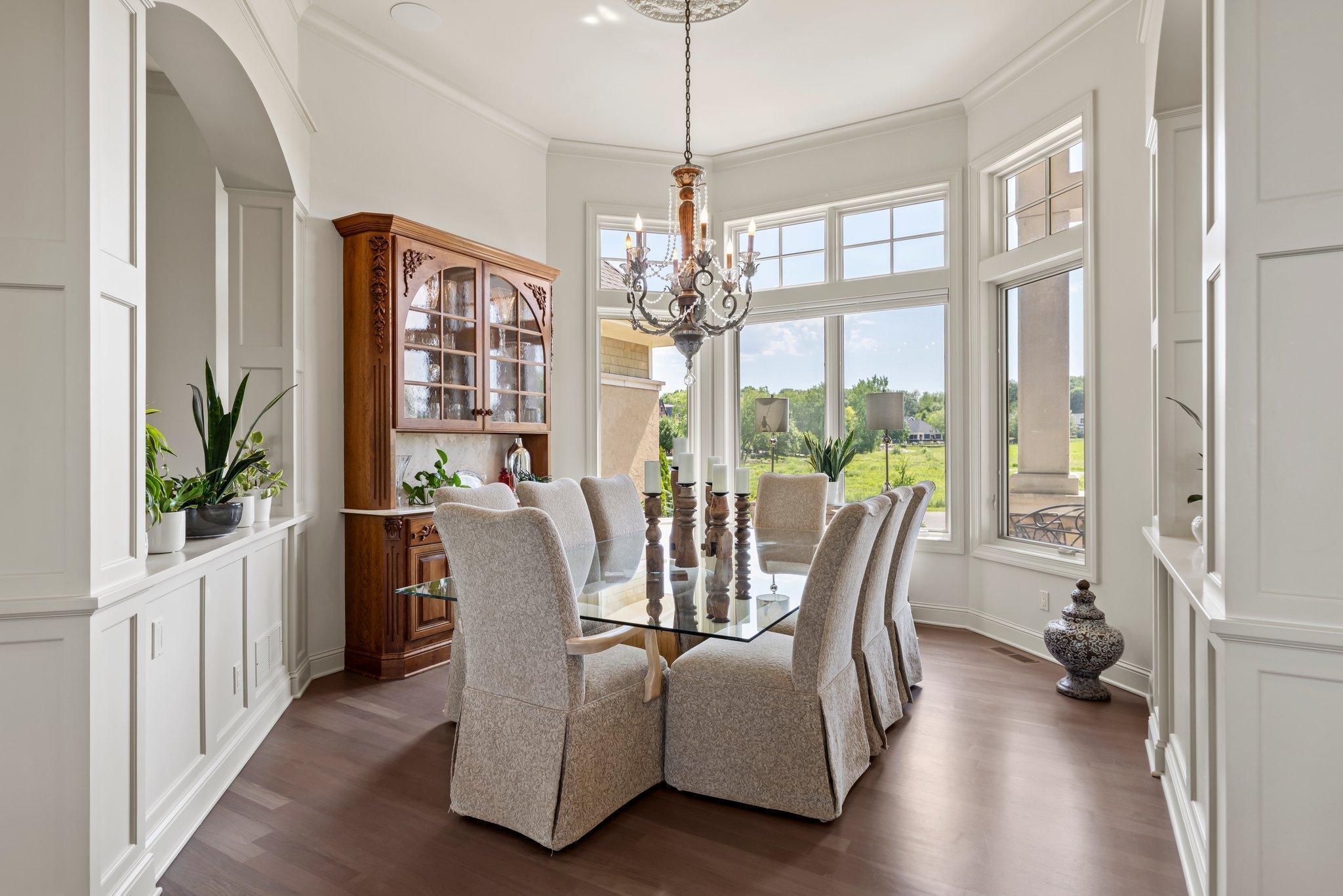 Formal dining room just off the front foyer with large windows, rich millwork, and elegant architectural details. Ideal for entertaining with natural light and space for a full dining set.