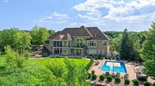 This private estate offers a resort-style backyard with pool, patio, fire pit, and lush lawn- framed by mature trees and scenic meadow views. A rare retreat just minutes from it all!