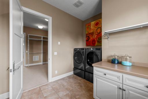 Main floor laundry room in the Primary bedroom suite. There is laundry in the lower level as well!
