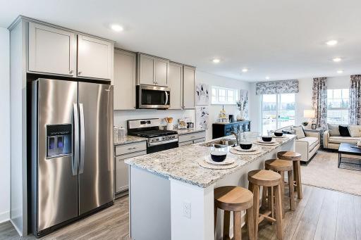 Beautiful high end kitchen with plenty of space to move around and entertain. Model picture shown. Colors and finishes may vary. Subject address is an interior unit. Exterior unit photos shown.