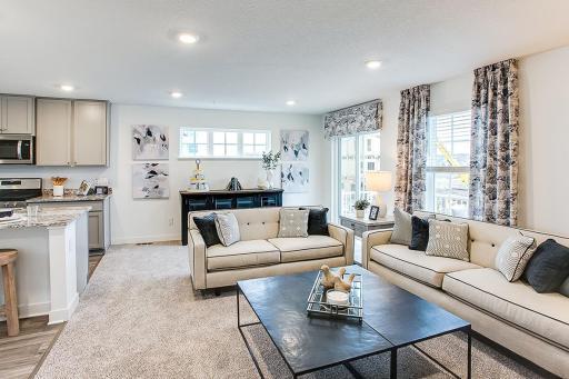 View of the large family room. Model picture shown. Colors and finishes may vary. Subject address is an interior unit. Exterior unit photos shown.
