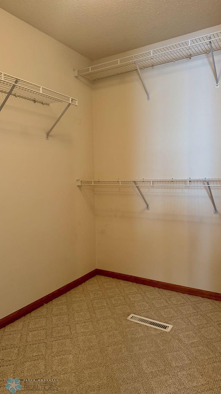 (23) Primary Bedroom Walk-In Closet.jpeg